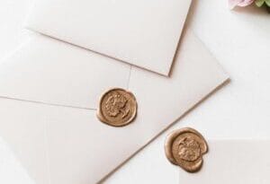 pexels photo 11385650 e1753250679699 Faith & Family white envelopes laying on white table and pinkish flowers