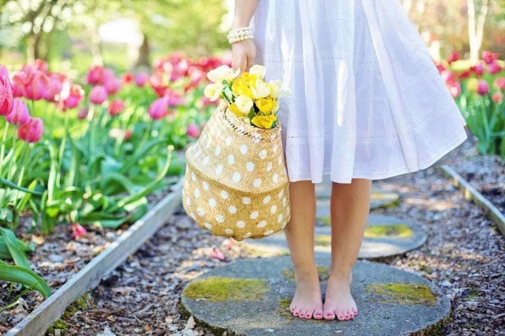 pexels photo 413707 woman holding brown basket with yellow flowers