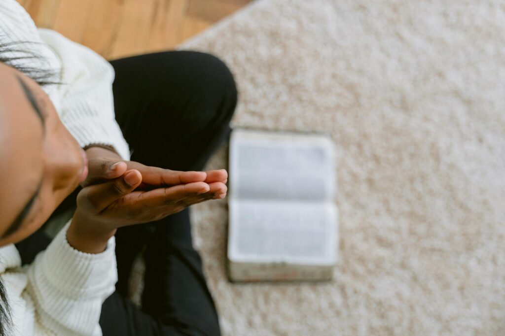 woman in white jacket praying